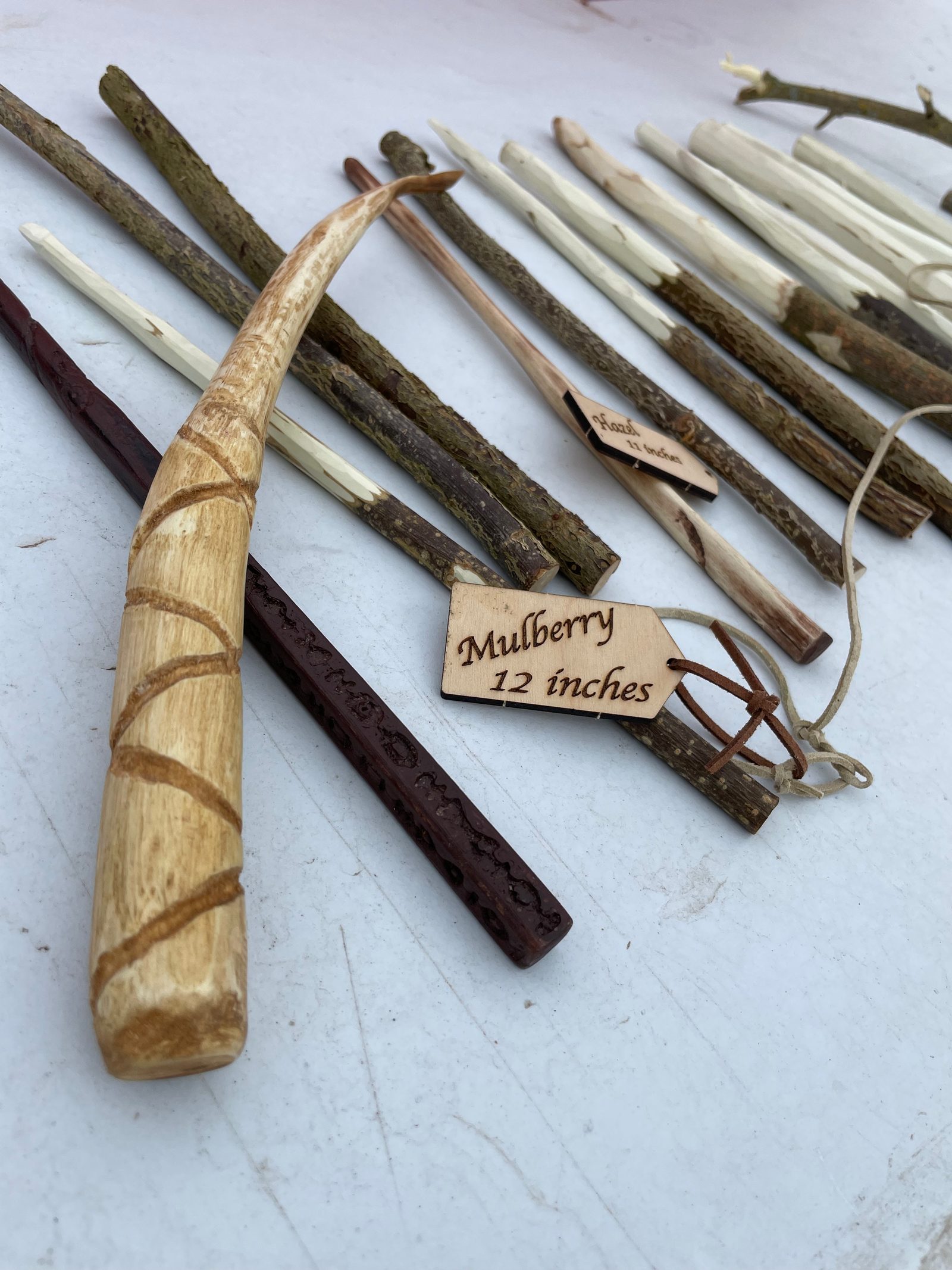 A display of finished wands with an Ollivanders-style tag reading Mulberry, 12 inches